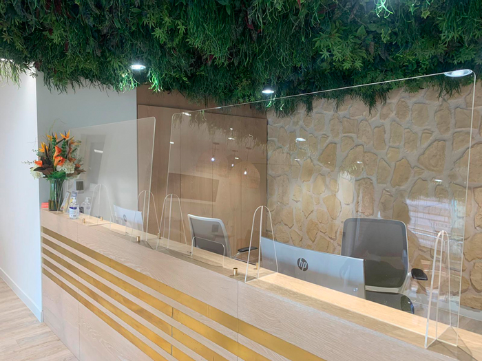 Transparent screen in front of reception desk