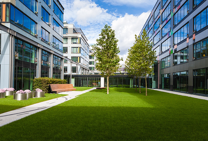 Office buildings with grass and trees between them