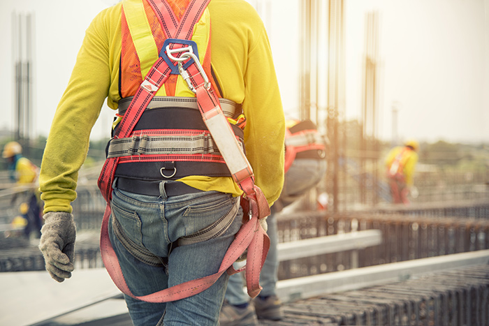 A scaffolder wearing safety a harness