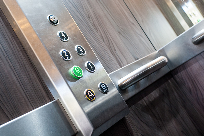 Lift controls, focussing on the emergency call button