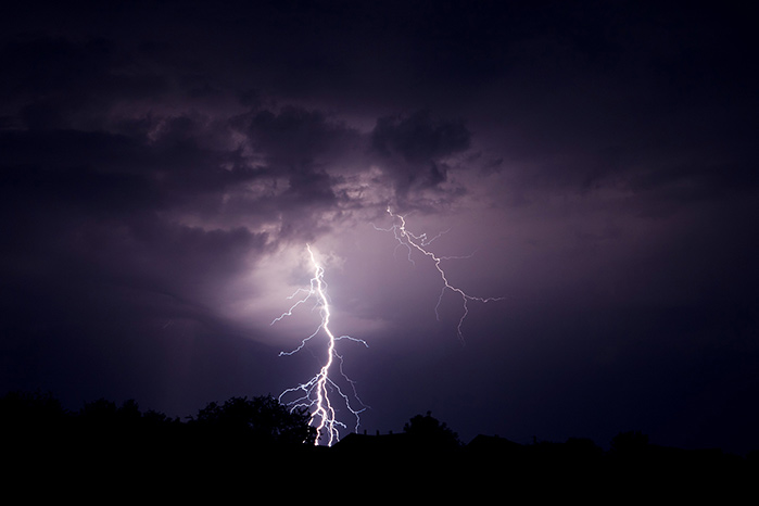 Lightning dramatically striking the ground at night