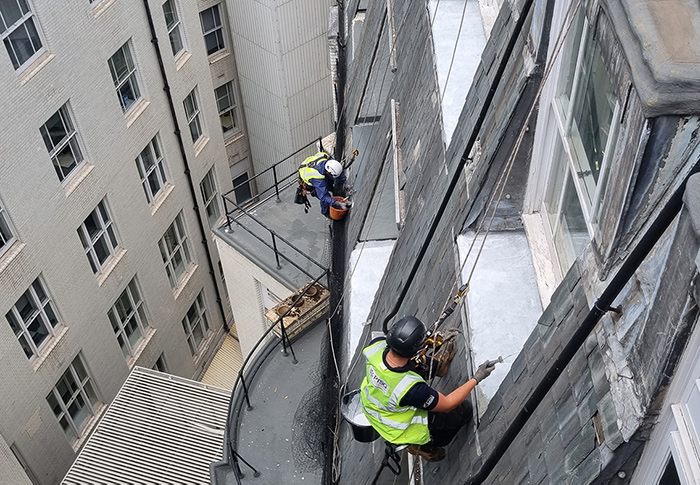 Two PTSG operatives working at height performing a façade restoration