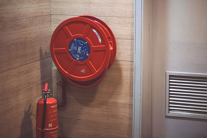 A fire extinguisher and fire hose